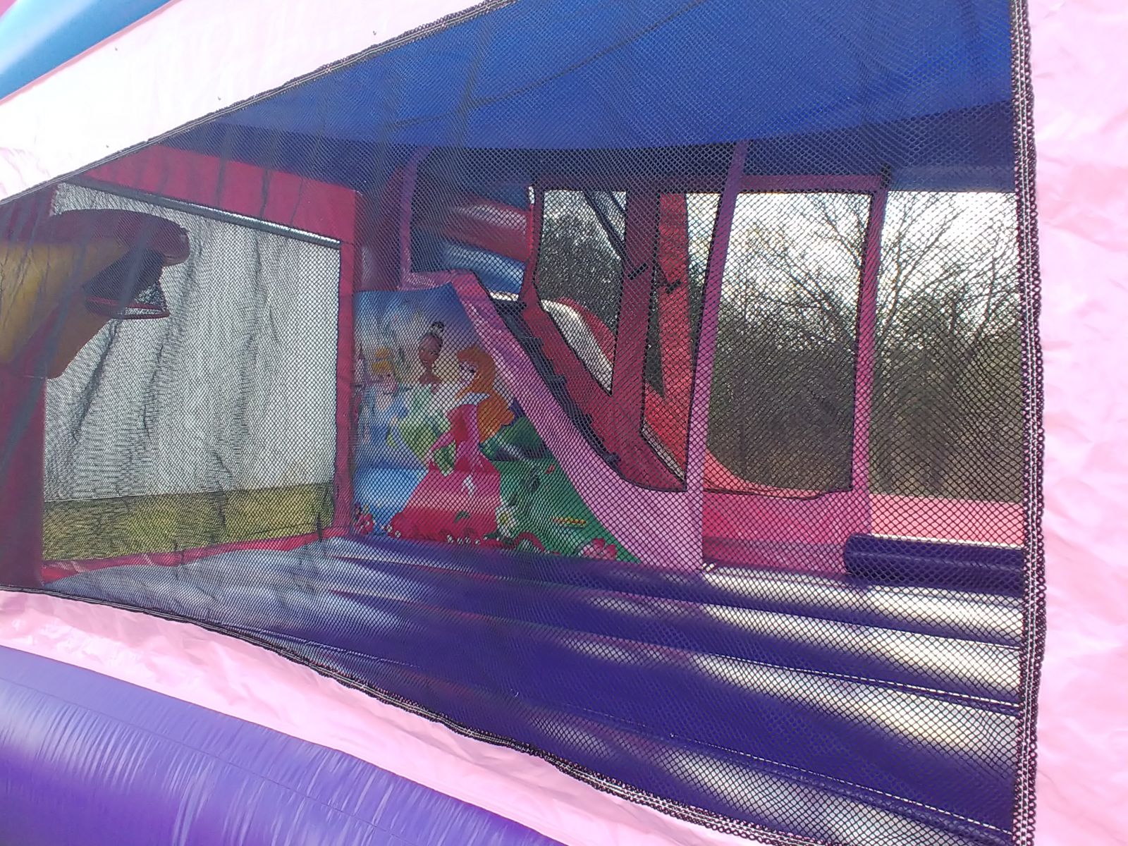 Disney Princess Combo interior view with basketball hoop and climbing wall with slide bounce house